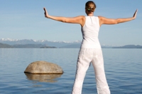 Woman practicing yoga at the beach